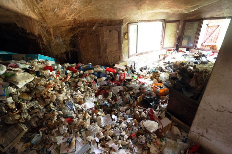 In the "living room"the kitchen, on the right, is also awash in waste.