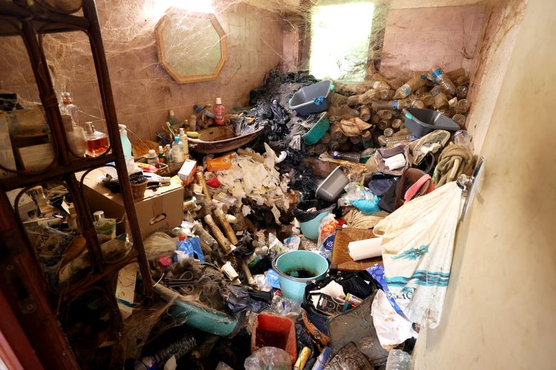 The bathroom, with a tub in the back, had long been unusable.